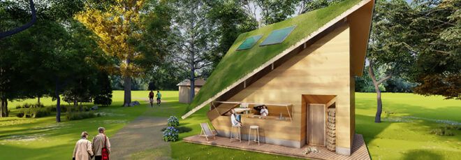 A triangular tiny home in a grassy area.