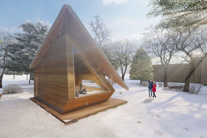 A triangular tiny home in a snowy area.