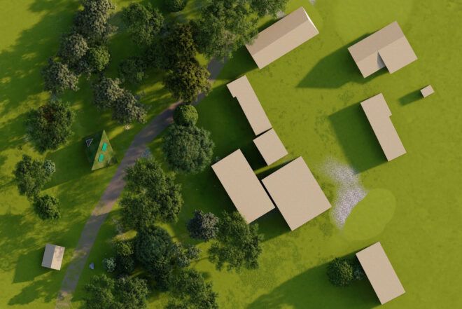 An aerial view of buildings in a grassy field.