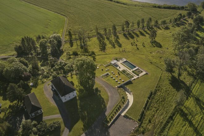 An aerial view of a villa with a green roof.