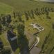 An aerial view of a villa with a green roof.