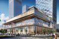 A square building full of glass windows sits at an intersection in the city
