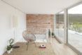 A living area with a brick wall and wood floor.