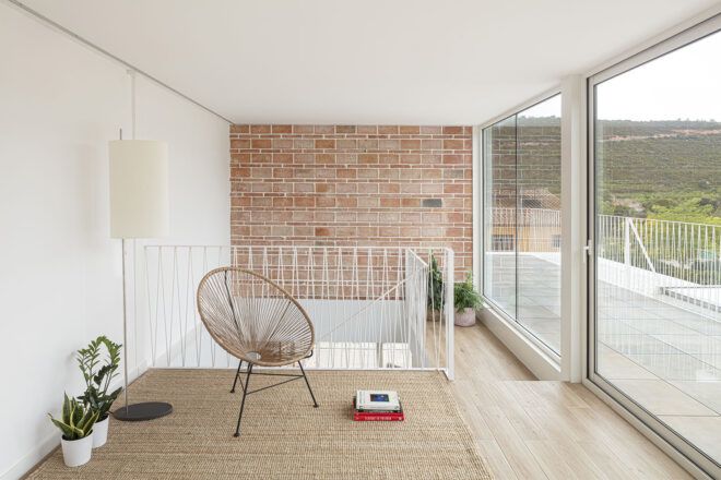 A living area with a brick wall and wood floor.