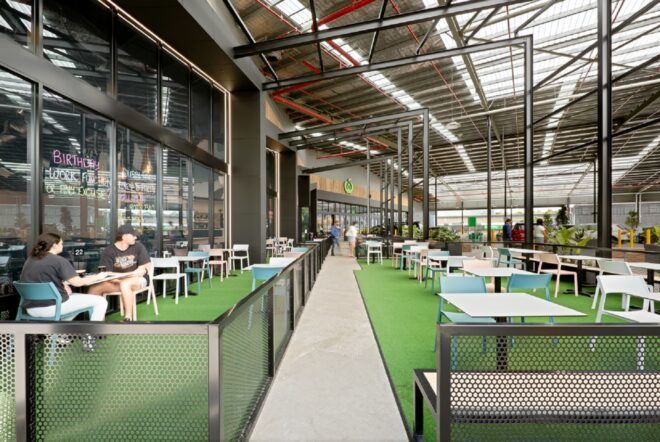 Inside the industrial complex but outside the shop there is a seating area with fake grass