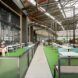 Inside the industrial complex but outside the shop there is a seating area with fake grass