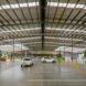 A large industrial parking lot that leads to a supermarket