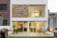The exterior of a brick home with a yard.