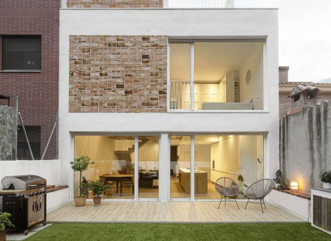 The exterior of a brick home with a yard.