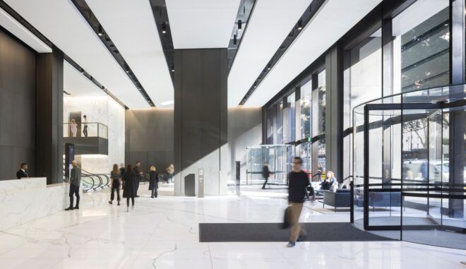 The inside of the building has white ceiling and white tile floors from a revolving door