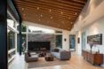 A living room with wood features and a fireplace.
