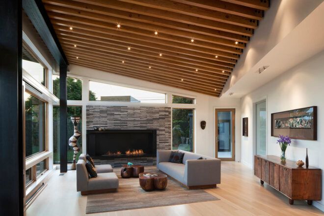 A living room with wood features and a fireplace.