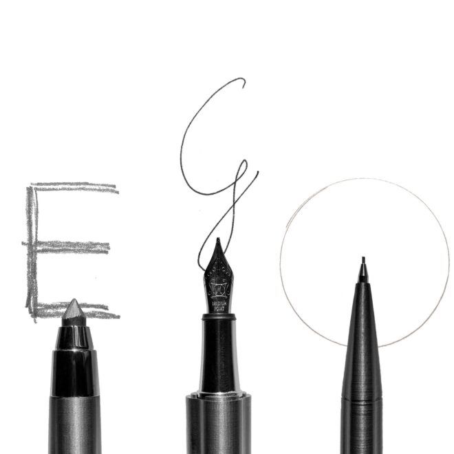 A pencil, a fountain pen and a pen with the writing of letters E, G and O spelled across the three different types of writing utensils