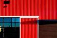 An up close of the red wooden panels that make up the barn