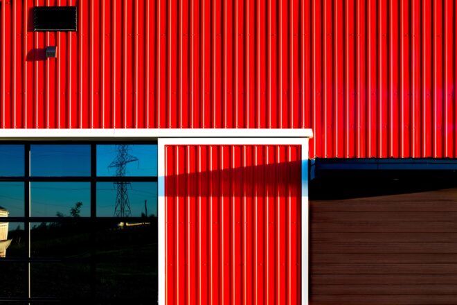 An up close of the red wooden panels that make up the barn