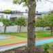 A grassy area that is divided as a basketball court and a grass area