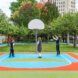Three young kids playing basketball on a single hoop