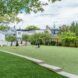 A grass area where there are young kids playing