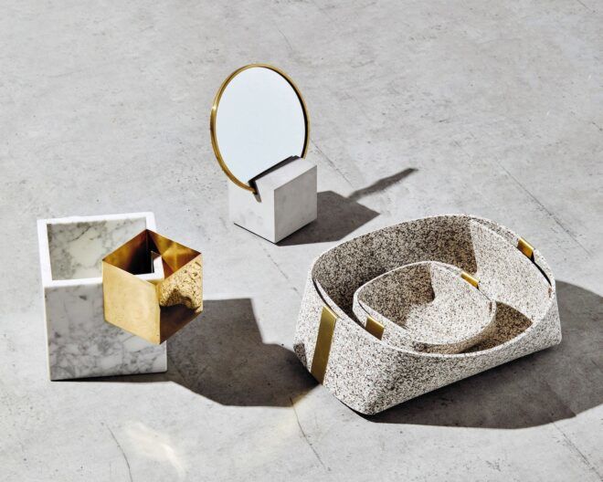 Various trinket holders including a small tray inside a larger tray, a mirror on a stand and a box with a gold design at the edge. They are designed by Slash Objects that recycles waste into beauty.