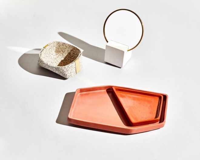 An orange trinkets tray that has two sections to it, an open box and a mirror