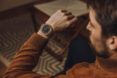 A brown watch on a person's wrist.