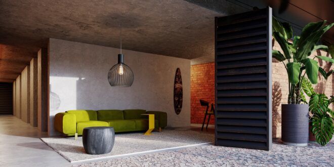 A living room space which has a green sofa and a hanging light in front of it