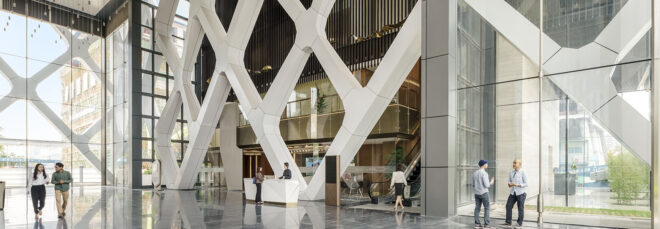 A lobby with a large white crisscrossing wall design.