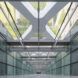 A view looking down a glass corridor.