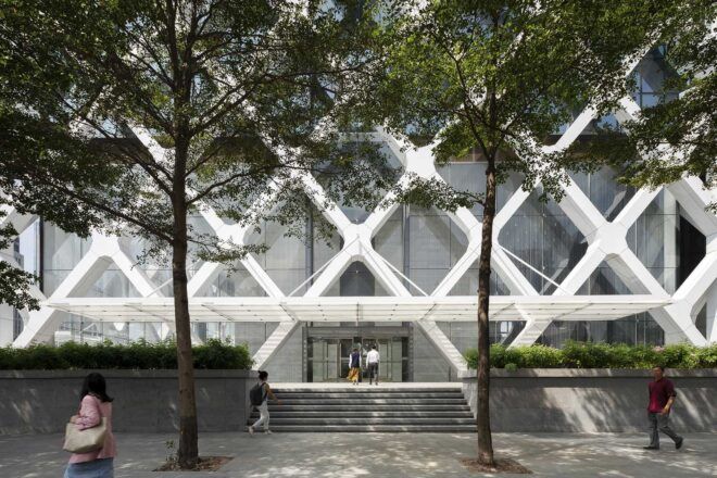 The entrance to a building with a crisscross exterior.