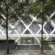 The entrance to a building with a crisscross exterior.