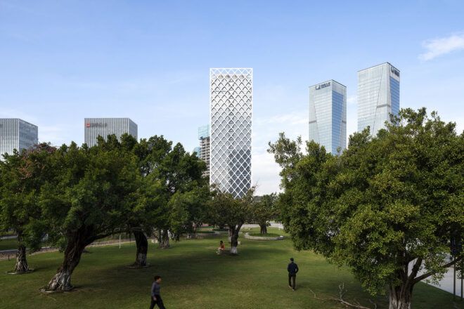 A green park in front of a biophilic design skyscraper.