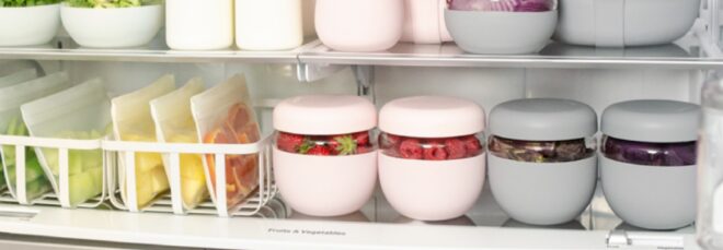 A shelf in a fridge containing different storage containers and round tubberwares