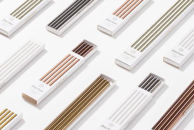 A set of metal straws laid flat on a white surface