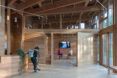 A wood lobby area with visitors milling around.