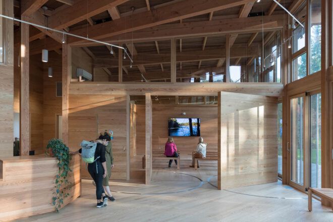 A wood lobby area with visitors milling around.