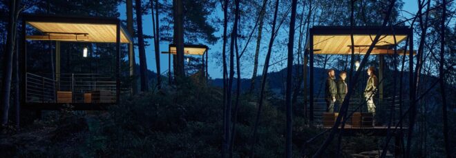 During night time, the structures light up for campers within the forest