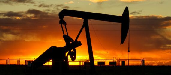 An oil well at sunset.
