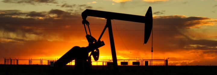 An oil well at sunset.