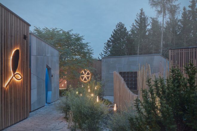 A foggy wellness garden with buildings separately placed and stone pavements
