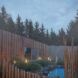 A wooden building faces a wellness pool