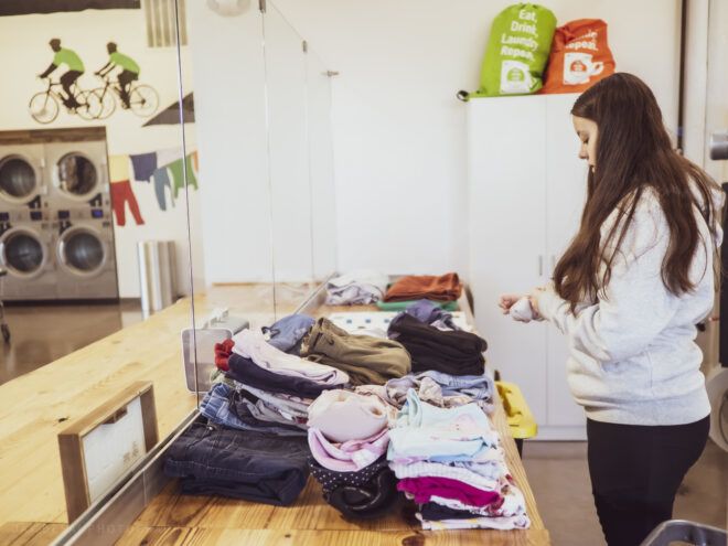 Woman folding and sorting her laundry into piles