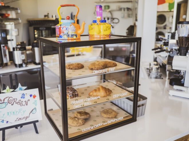 Cafe countertop with various baked goods in a glass display case