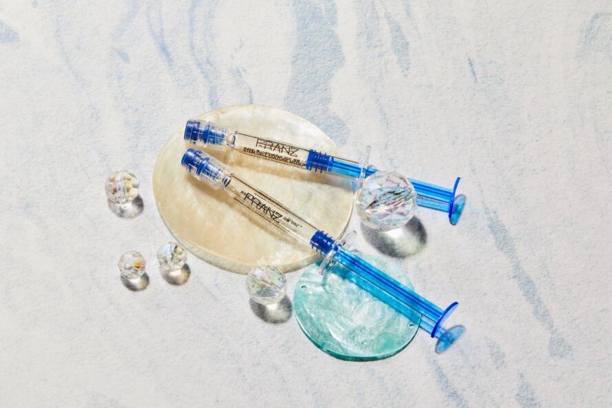 Two serum packaging with blue handles