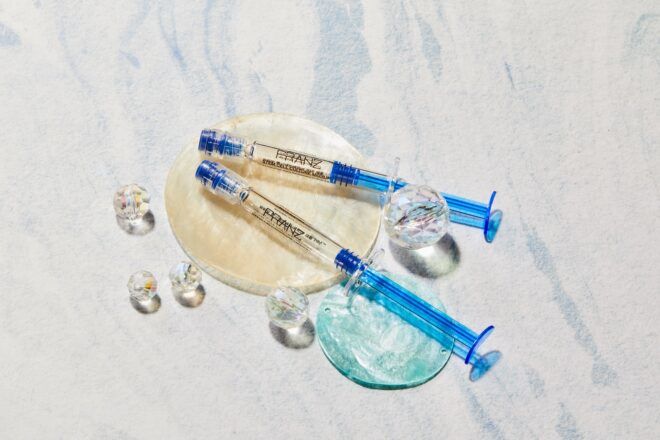 Two serum packaging with blue handles