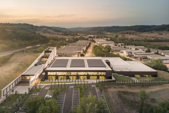An aerial view of the Furla Headquarters situated beside a hill scenery