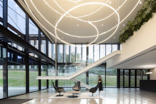 Interior lobby area includes chairs and a stairway that leads up to the second floor