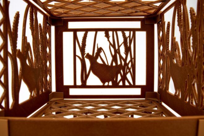 A wooden mesh design that shows a cutout of a chicken in the center