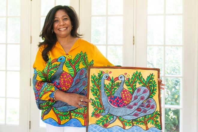 A person in a sustainable silk shirt posing next to a picture of the shirt design.