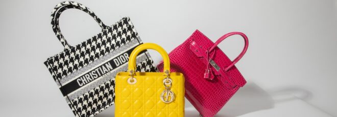 Three handbags including a black-and-white houndstooth, a pink handbag and a yellow handbag