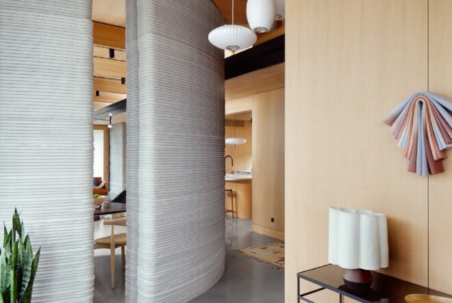 A grey wall that divides two walkways